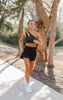 beige hour running shorts in carbon black with movement one shoulder bra